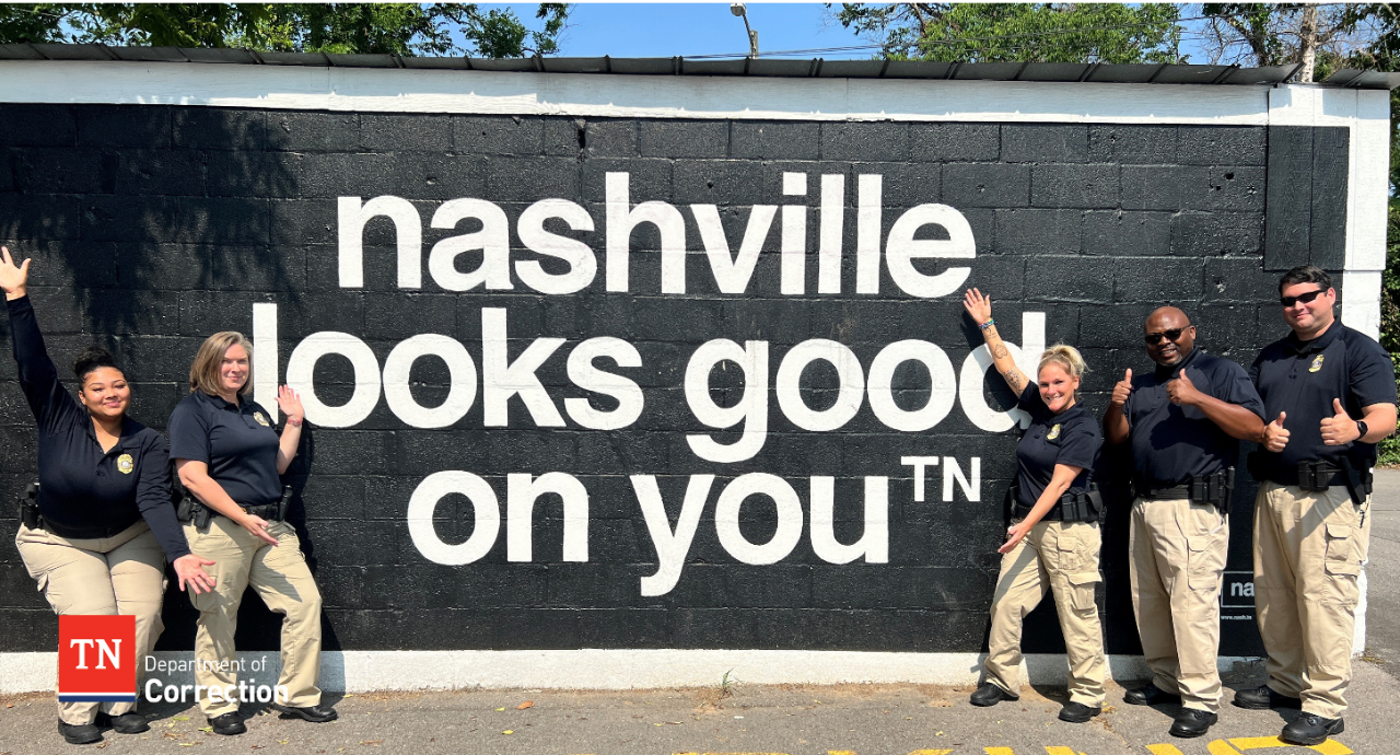 Photo of probation parole officers with Nashville mural