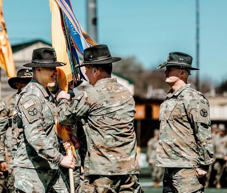 Col. Donny Hebel receives the unit colors from Brig. Gen. Steven Turner, Tennessee’s Assistant Adjutant General-Army, during the 278th Armored Cavalry Regiment’s change of command ceremony, March 10, at Knoxville’s West High School. (Photo by Staff Sgt. Art Guzman)